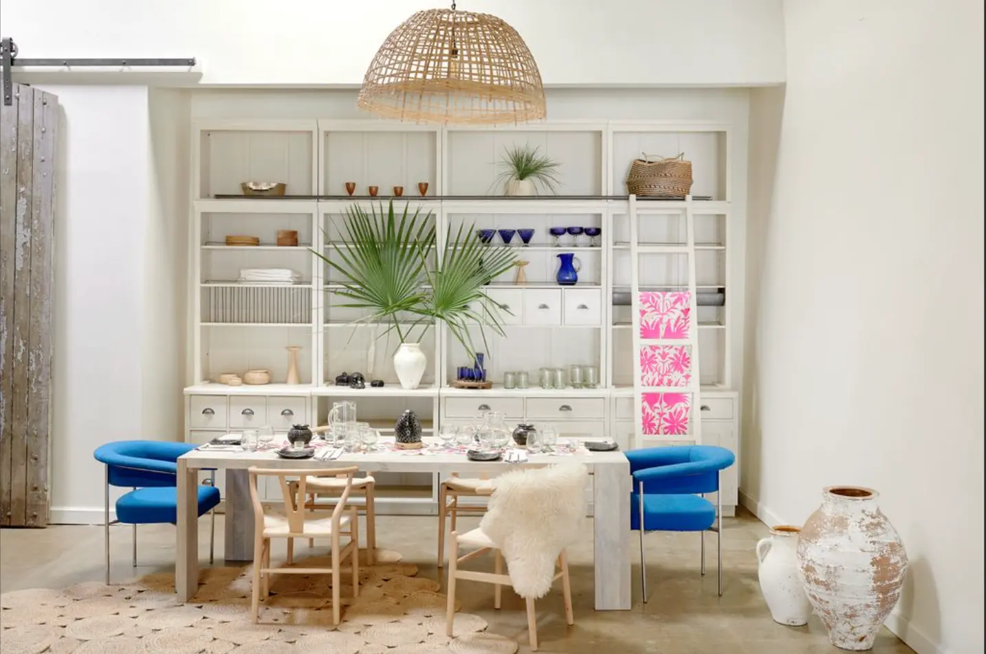 Casa de Coco dining room layered with handcrafted glassware, ceramics, and textiles