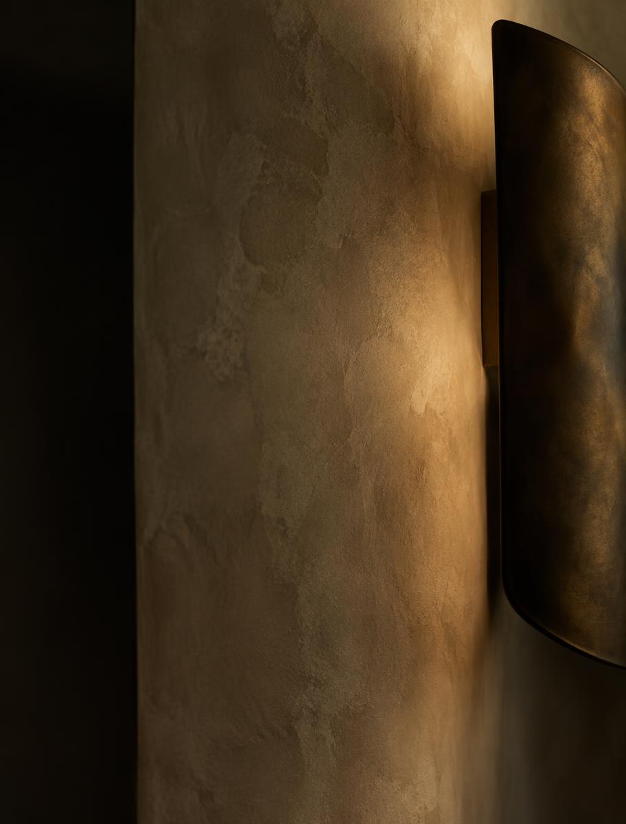 Hand-applied limewash and patinated bronze lighting detail